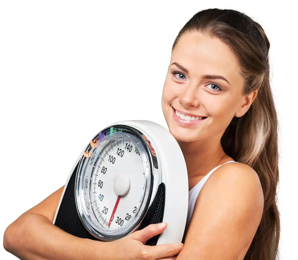 Smiling woman holding a bathroom scale